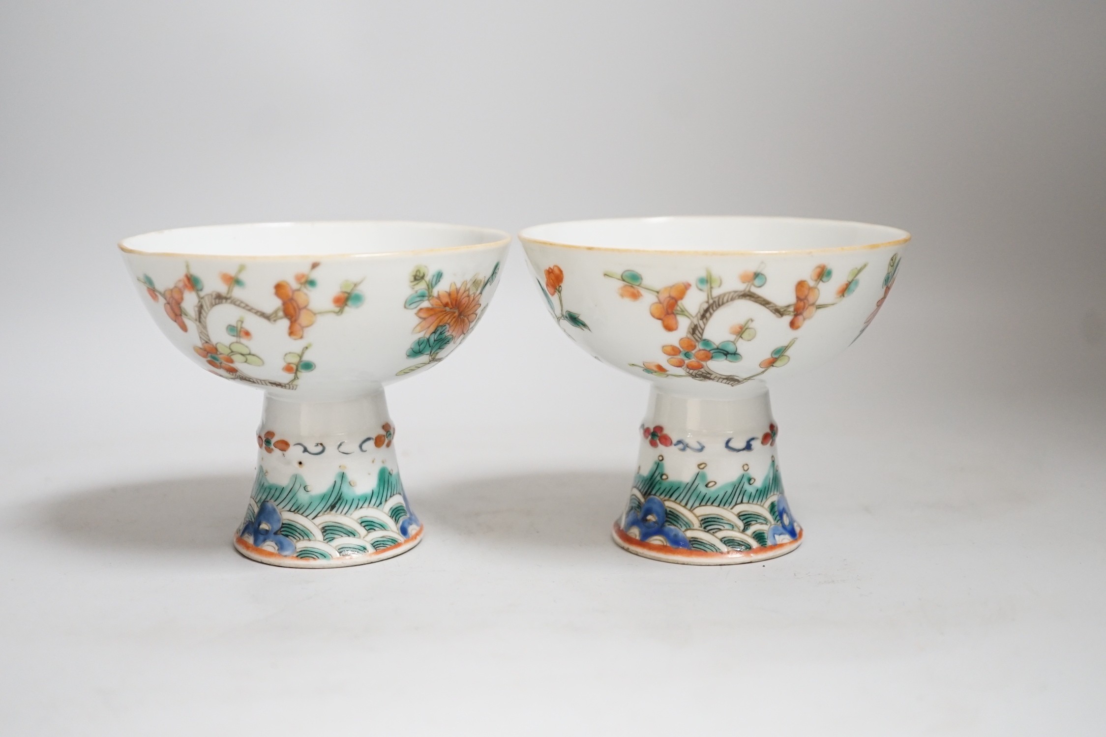 A pair of 19th century Chinese stem cups with four flower design, 9cm